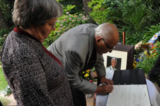 ANC stalwart Ahmed Kathrada and former Minister Barbara Hogan sign the registry book at the former South African President Nelson Mandela's house in Houghton, Johannesburg