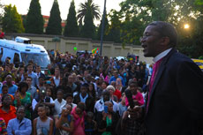 Reverend Mpumlwana holding a short prayer for hundreds of mourners from around the country who gathered outside Former President Nelson Mandela's house in Houghton, Johannesburg